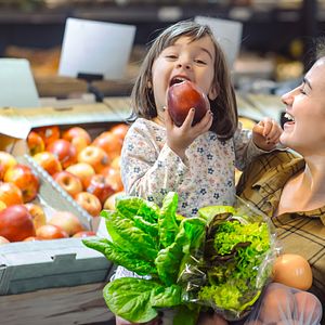 Mom and daughter eating apple