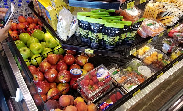 Images of fresh and healthier food options such as fruits and veggies available for purchase at a Kwik Trip convenience store. 