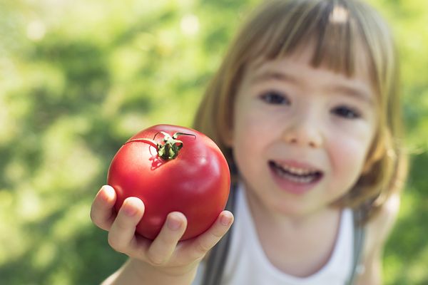 Little girl holding an apple