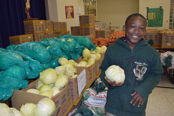 Kid with cabbage at Capital Area Food Bank in Washington DC
