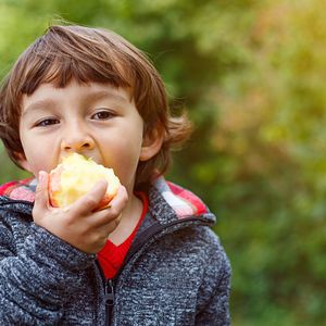 Boy eating apple