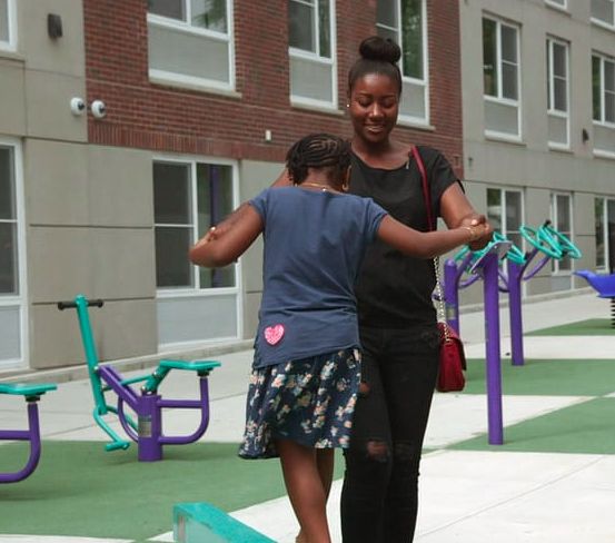 Kiana and her mother at Blue Sea Development's Prospect Plaza housing, a development that utilizes active design strategies. 