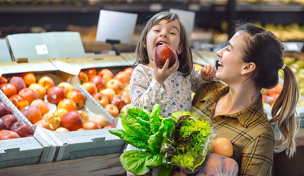 Mom and daughter eating apple
