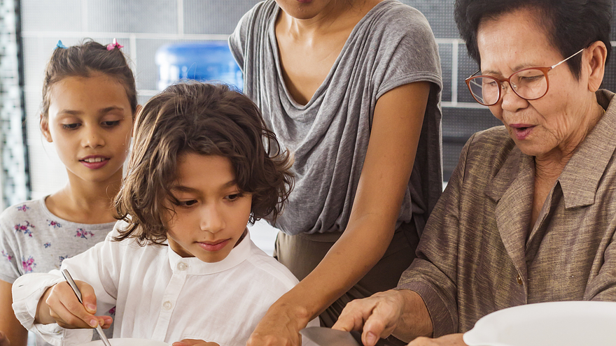 A family cooks together in the kitchen