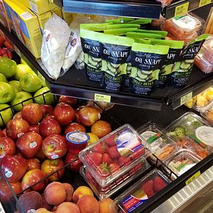 Images of fresh and healthier food options such as fruits and veggies available for purchase at a Kwik Trip convenience store. 