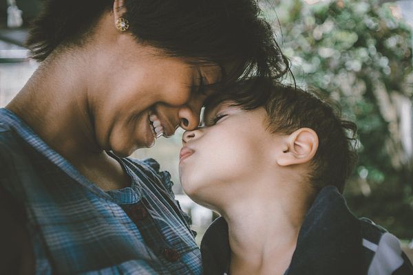 Image of a mom and a son embracing. 