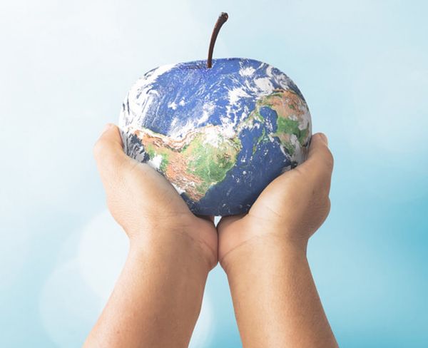 Child holding the globe shaped as an apple