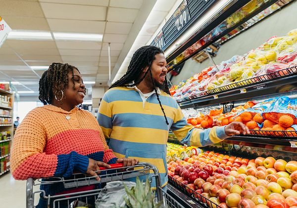 Smiling couple shops for groceries