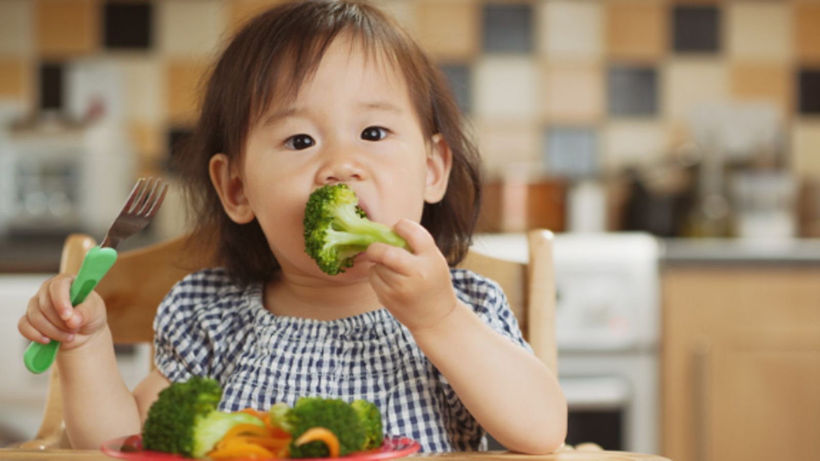 Image of toddler eating broccoli and vegetables