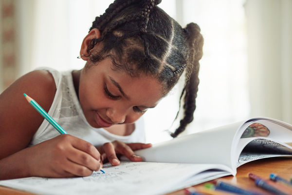 School aged child is coloring.