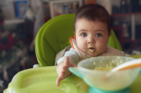 baby eating green vegetables