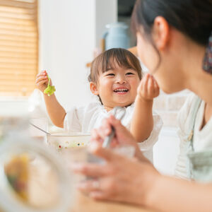 A woman and her daughter enjoy a healthy meal