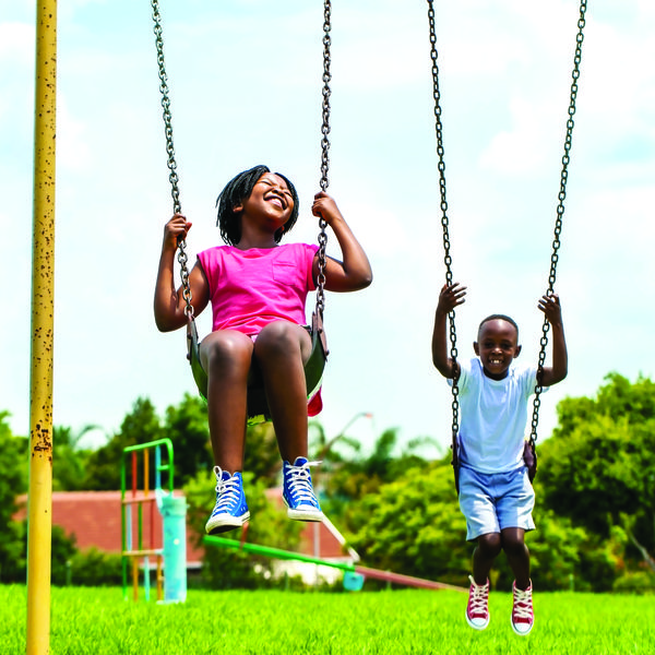 Image of two children on a swing. 