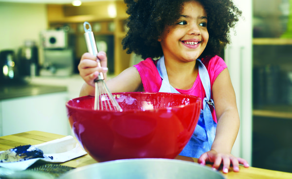 Image of a girl stirring food. 