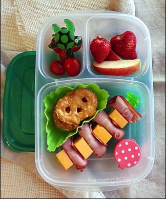 Image of fruits, crackers and cheese in a children's lunchbox container. 