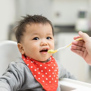 Baby eating veggie-forward product