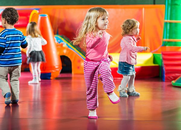 Image of young child dancing at an early child care center. 