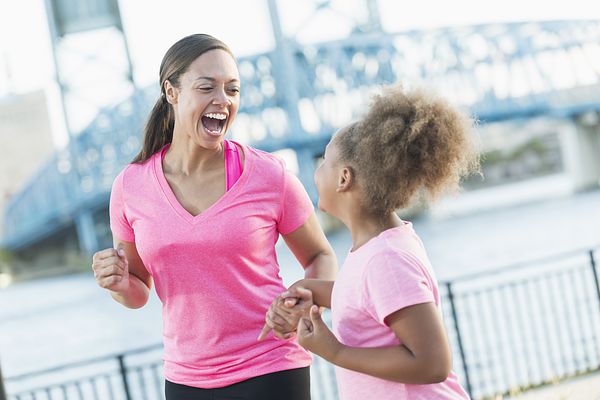 Image of a mother and daughter running together. 