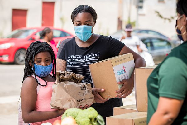 Mom and daughter with Pass the Love meal box