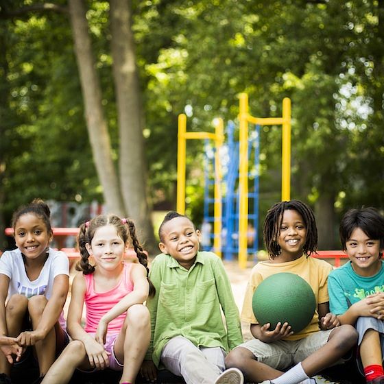 Image of children sitting outside after recess.