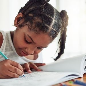 School aged child is coloring.